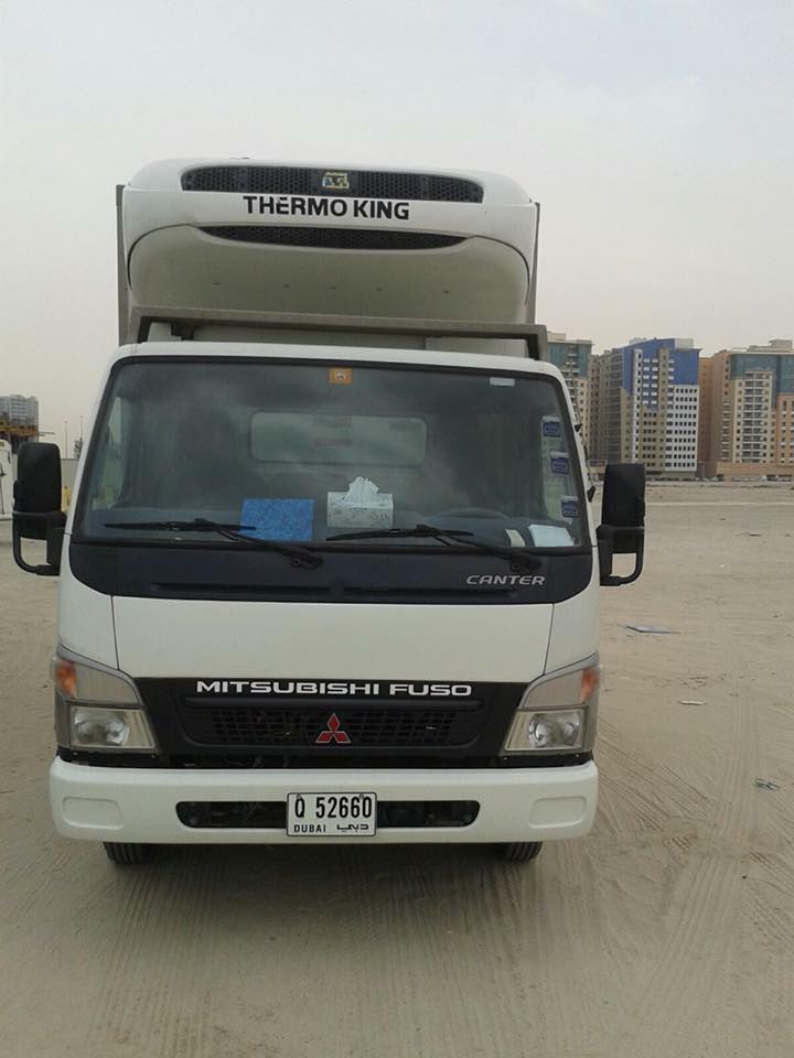 Chiller truck loading chilled goods for supermarket delivery in Dubai